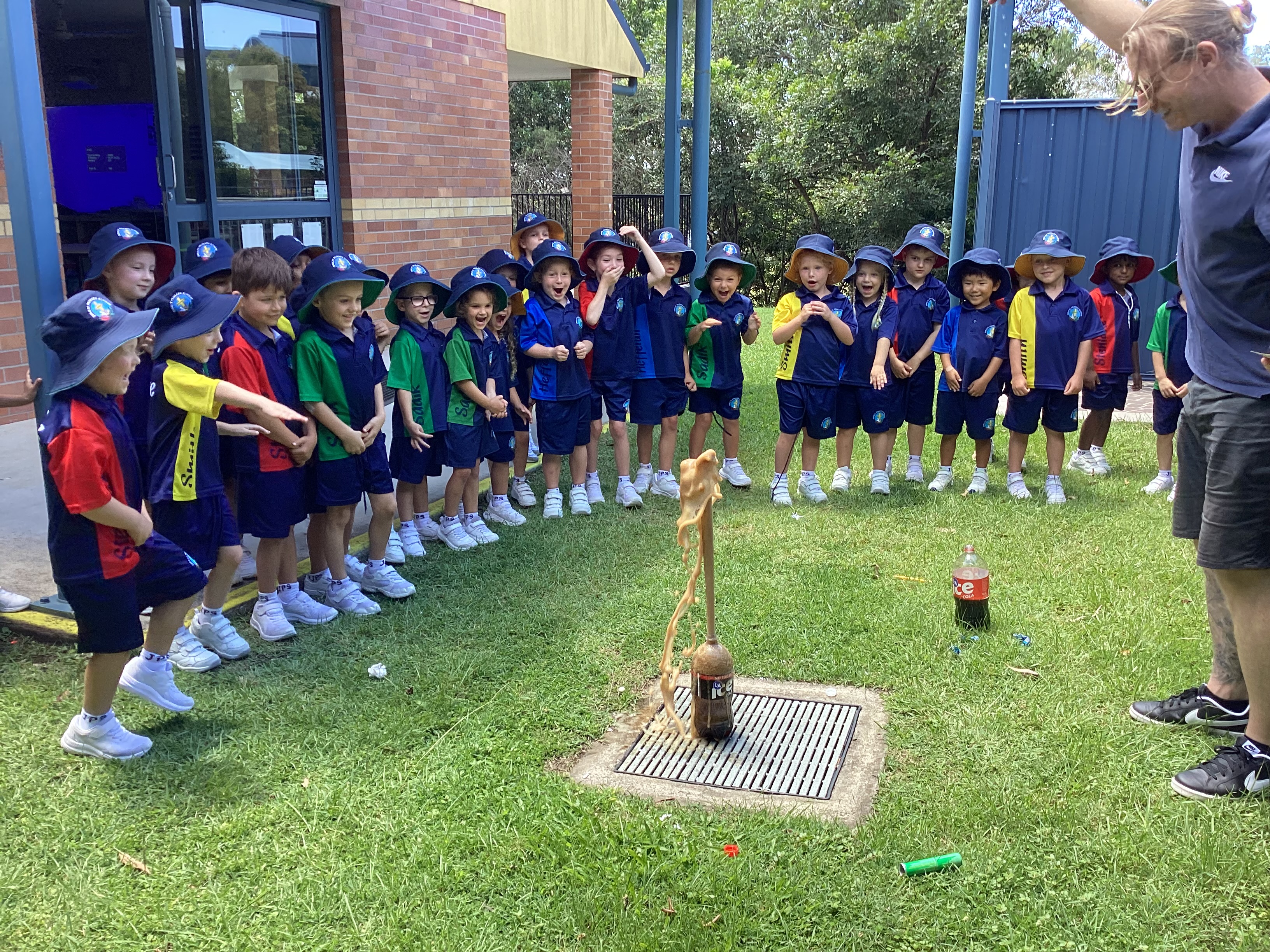 students watching mentos explode in coke bottle