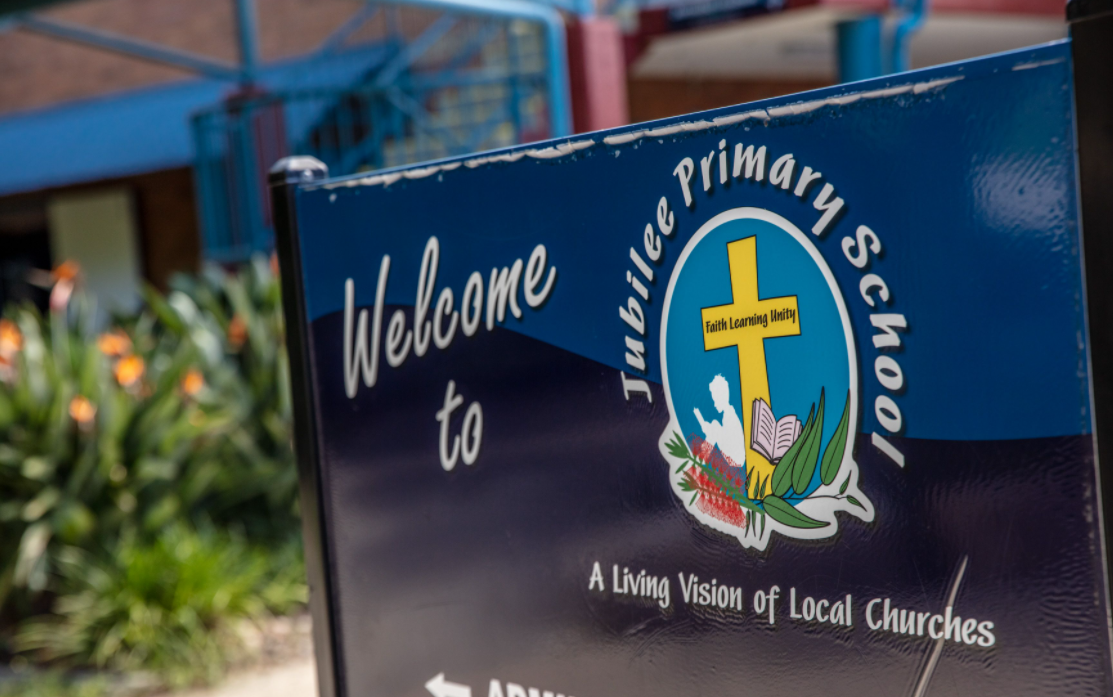 Welcome sign at the entrance of Jubilee Primary School featuring the school logo and the words ‘Welcome to Jubilee Primary Schoo